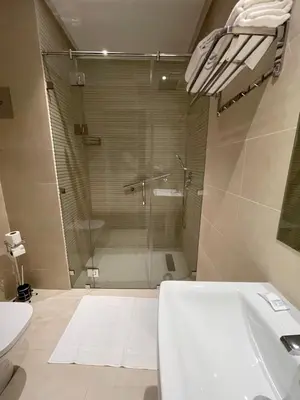 a bathroom with a shower and a toilet and a sink at Hotel De Nice in Meknès