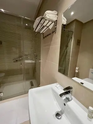 a bathroom with a toilet and a sink and a mirror at Hotel De Nice in Meknès