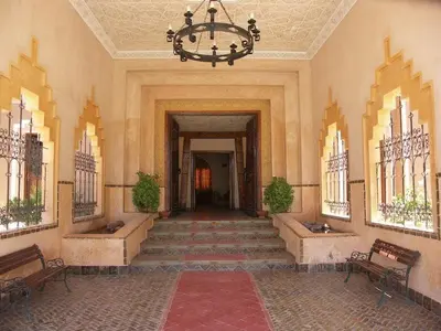 a hallway with stairs and a chandelier in a building at Hôtel Le Tinsouline in Zagora