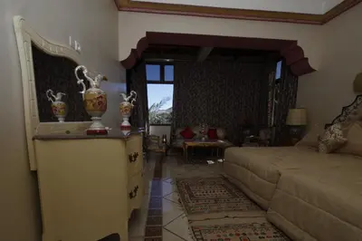 a living room with a couch and a table at Hôtel Le Tinsouline in Zagora