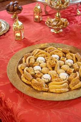 a plate of food on a red table at Hotel Kasbah Azalay in Mhamid