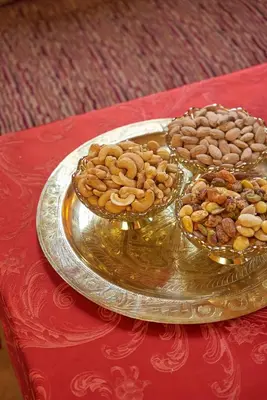 a plate of nuts and other food on a table at Hotel Kasbah Azalay in Mhamid