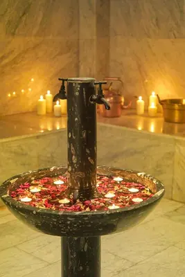 a fountain in a room with candles on a table at Hotel Kasbah Azalay in Mhamid