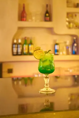 a green drink sitting on top of a table at Hotel Kasbah Azalay in Mhamid