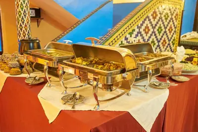 a buffet of food on top of a table at Hotel Kasbah Azalay in Mhamid