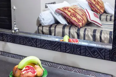 a bowl of fruit on a table in a bedroom at Hotel Azoul in Ouarzazate