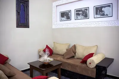 a living room with a couch and a table at Hotel Azoul in Ouarzazate
