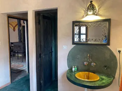 a bathroom with a sink and a mirror at Les 4 Saisons Du Dades in Aït Idaïr