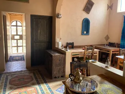 a room with a table and a door and a room with a table sidx sidx at Les 4 Saisons Du Dades in Aït Idaïr
