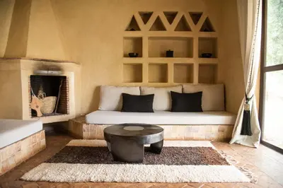 a bedroom with a bed and a table in a room at Jnane Allia in Douar Soukkane