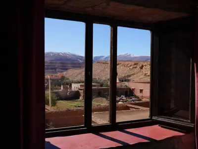 a window with a view of the mountains at Auberge Hostel Traditionnel in Tinerhir