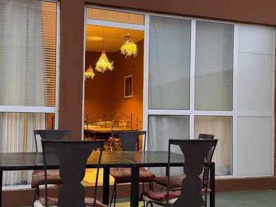 a dining room with a table and chairs at Dar Talhaya in Kasr Bounou
