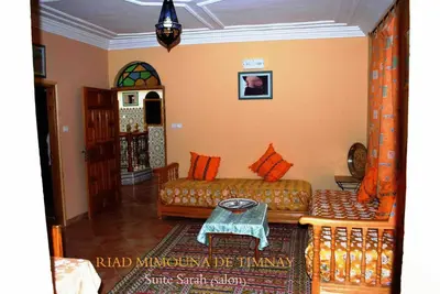 a living room with a couch and a table at Riad Mimouna De Timnay in Aguelmous