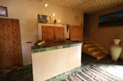 a kitchen with a counter in a room with stairs at Dar Sofar in Agdz
