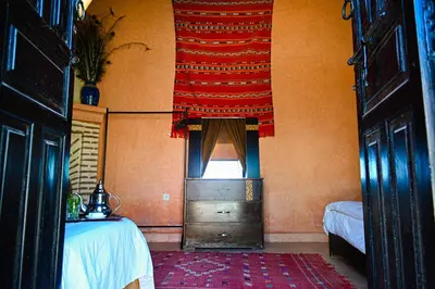 a room with a bed and a window with a curtain at Riad Sidi Hicham in Marrakech