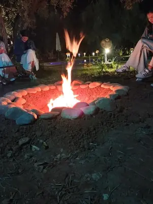 a fire pit in a park at night at Riad Sidi Hicham in Marrakech