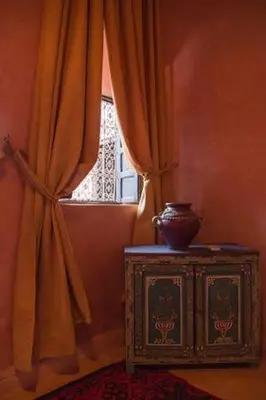 a window with a vase on top of a dresser in a room at Riad Sidi Hicham in Marrakech