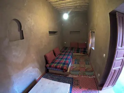 a room with a bed and a couch in a room at Authentic riad & activities Erg in Mhamid