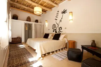 a bedroom with a large bed in a room at Maison d'Hôtes Irocha in Tisselday
