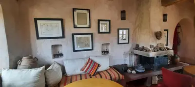a living room with a couch and a fireplace at Maison d'Hôtes Irocha in Tisselday