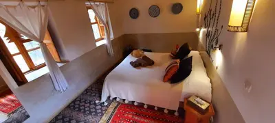 a bedroom with a bed with two teddy bears on it at Maison d'Hôtes Irocha in Tisselday