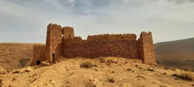 an old building on a hill in the desert at Maison d'Hôtes Irocha in Tisselday
