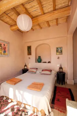 a bedroom with a large bed in a room at Maison d'Hôtes Irocha in Tisselday