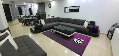 a living room with a couch and a table at Villa Nour in Fès