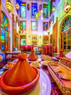 a room with a table with plates of food at Riad Verus in Fès