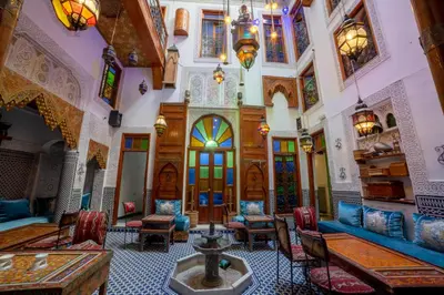 a large room with tables and chairs in a building at Riad Verus in Fès