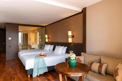 a hotel room with a large bed and a couch at Widiane Resort in Bine el Ouidane