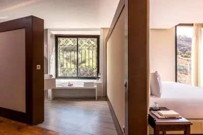 a bedroom with a large bed and a window at Widiane Resort in Bine el Ouidane