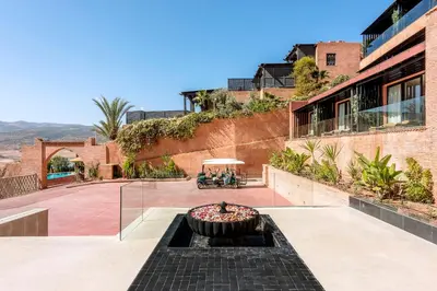 a courtyard with a fire pit in the middle of a building at Widiane Resort in Bine el Ouidane