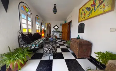 a living room with a black and white checkered floor at Riad Atika Mek in Meknès