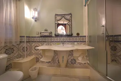 a bathroom with a sink and a toilet and a shower at Riad Atika Mek in Meknès