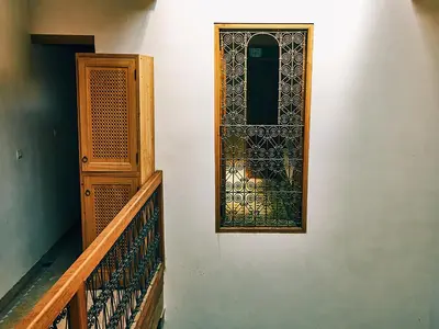 a door with a window on the side of a building at Dar Saida in Fès