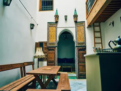a room with a wooden table and a door at Dar Saida in Fès