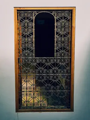 a wooden door with a black and gold design on it at Dar Saida in Fès