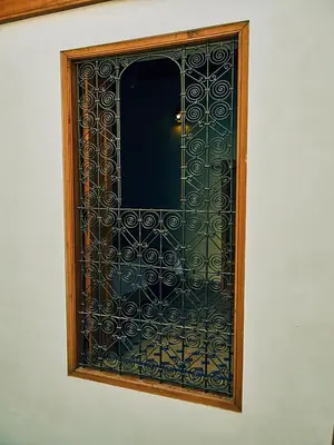 a glass door with a wooden frame on a wall at Dar Saida in Fès