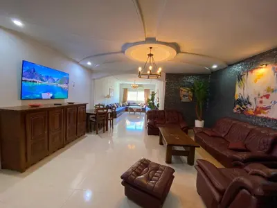 a large living room with couches and a flat screen tv at Sweet Jacob's Apartments in Fès