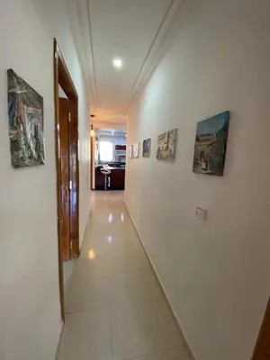 a hallway with paintings on the walls of a building at Sweet Jacob's Apartments in Fès
