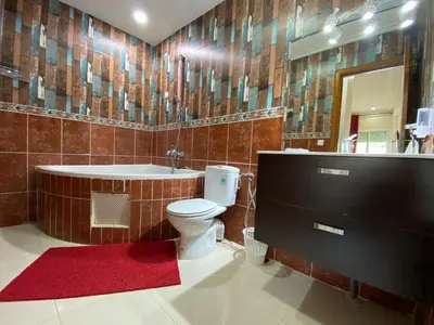 a bathroom with a tub and a toilet and a sink at Sweet Jacob's Apartments in Fès