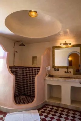 a bathroom with a sink and a mirror at Riad Azawad in Merzouga