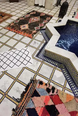 a tiled floor with colorful rugs on it at Palais didi in Meknès