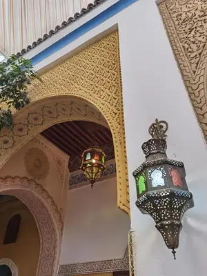 a lantern hanging from the wall of a building at Palais didi in Meknès