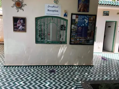 a building with a green door and a tile floor at Youth Hostel International Fez in Fès