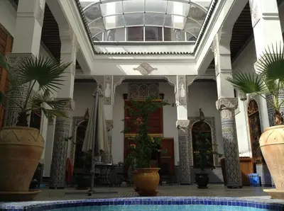a large building with a pool in the middle at Riad Soleil d'Or in Fès