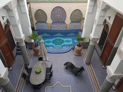 an overhead view of a lobby with a pool in a building at Riad Soleil d'Or in Fès