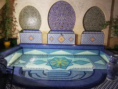a swimming pool with a tile floor in a building at Riad Soleil d'Or in Fès