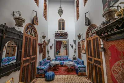 a room with a table and chairs in a room at Riad Les Idrissides Chez LEA in Fès